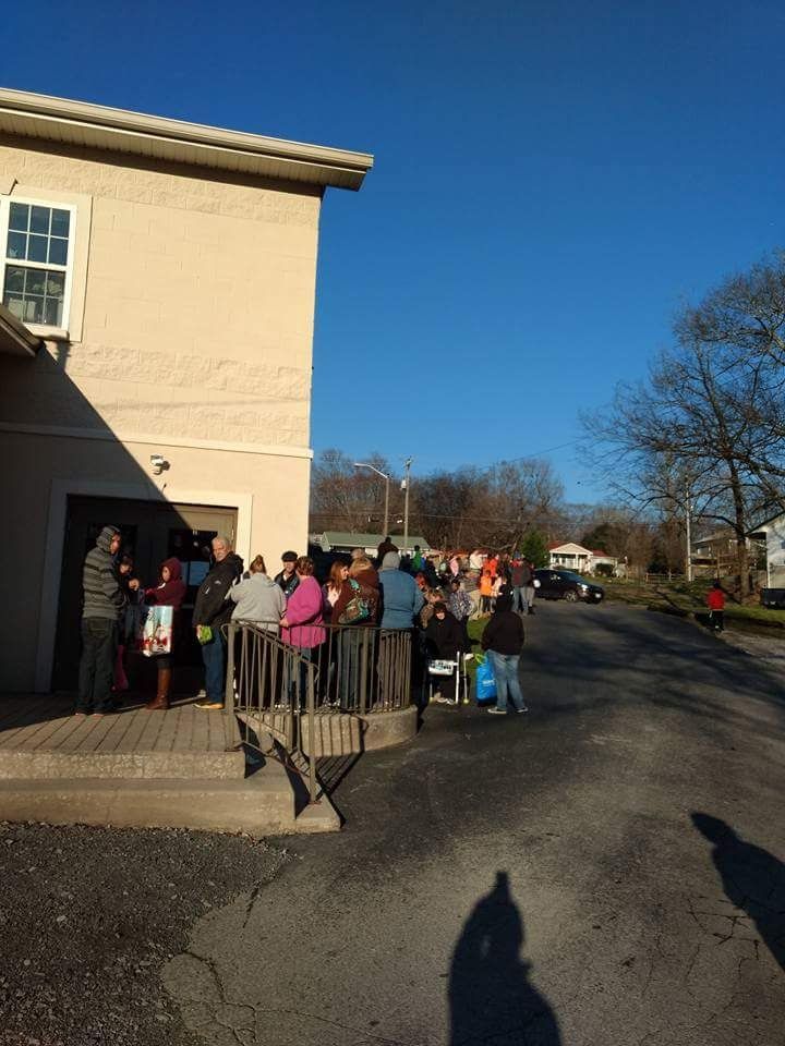 A group of people are standing outside of a building.