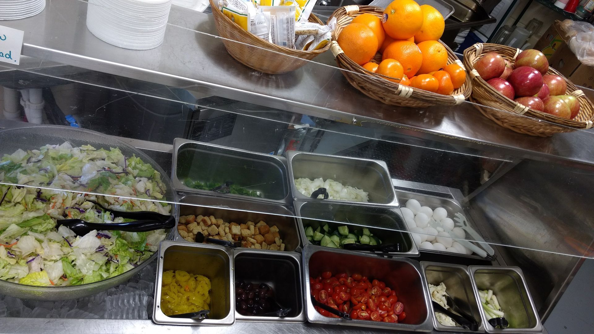 A salad bar with a variety of vegetables and fruits