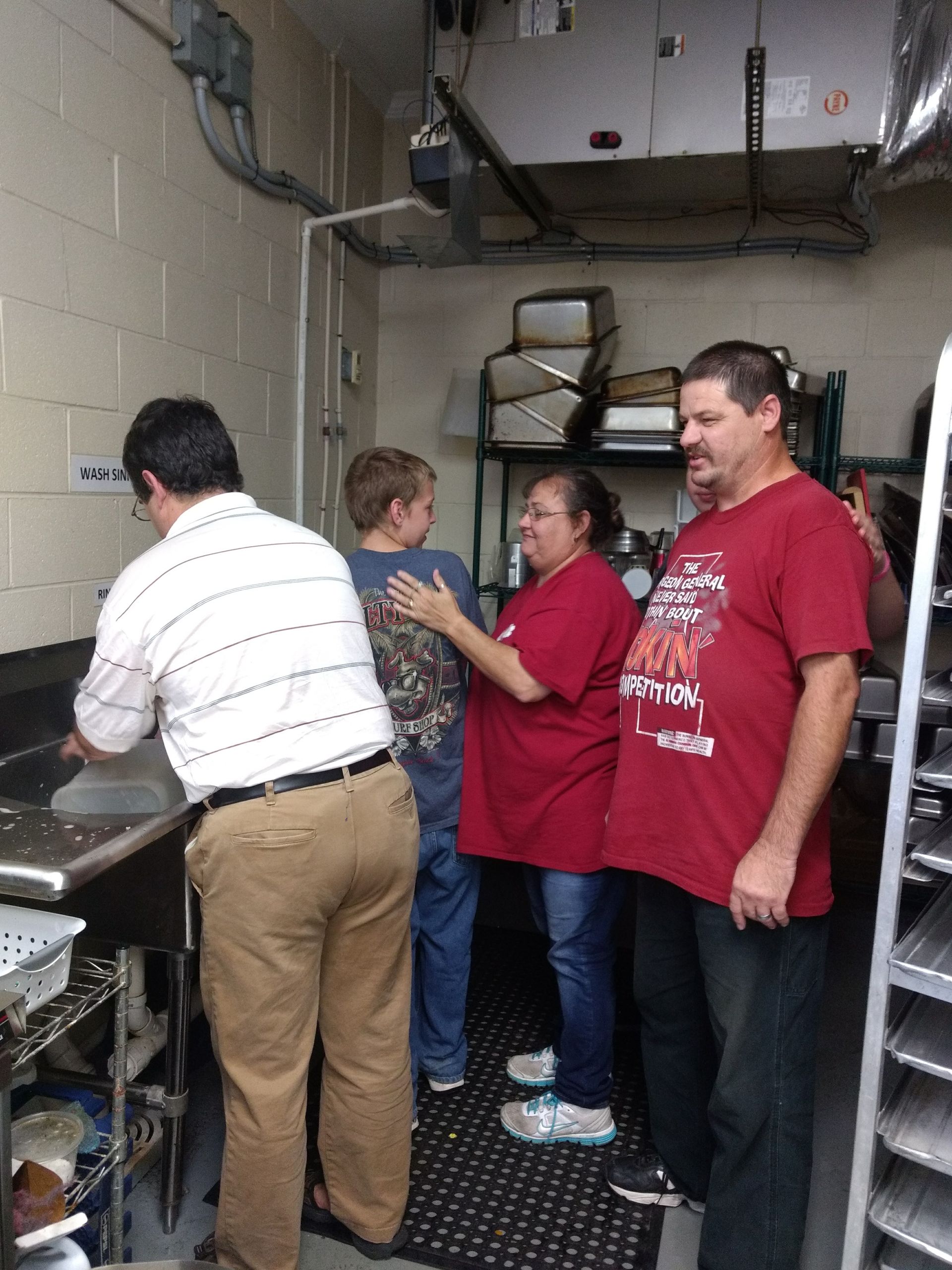 A man wearing a red shirt that says ' famous ' on it