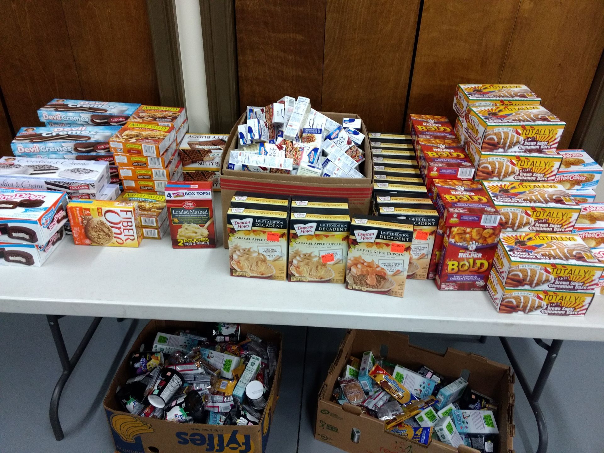 Boxes of food on a table including a box that says fries