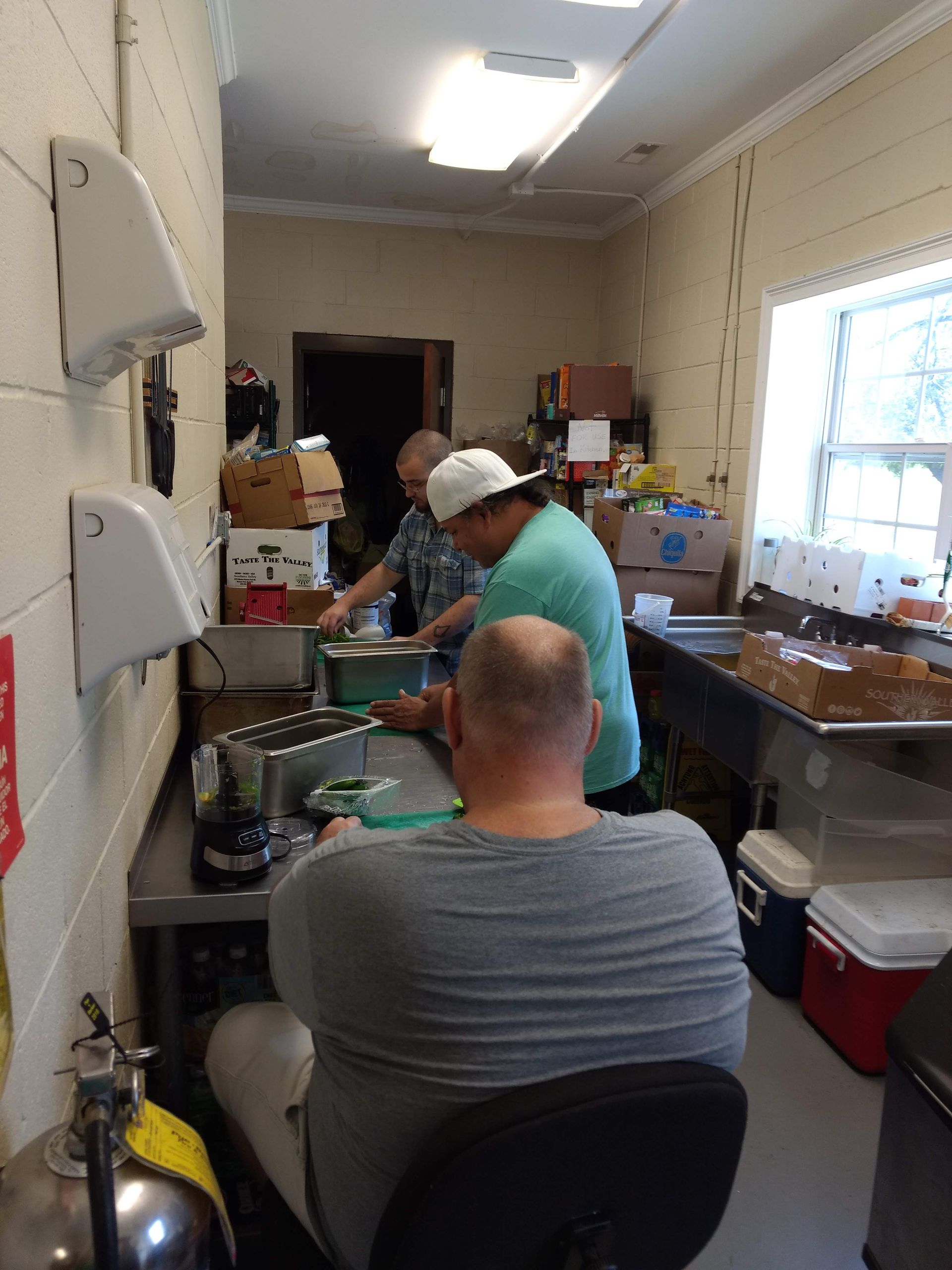 A group of people are working in a kitchen.