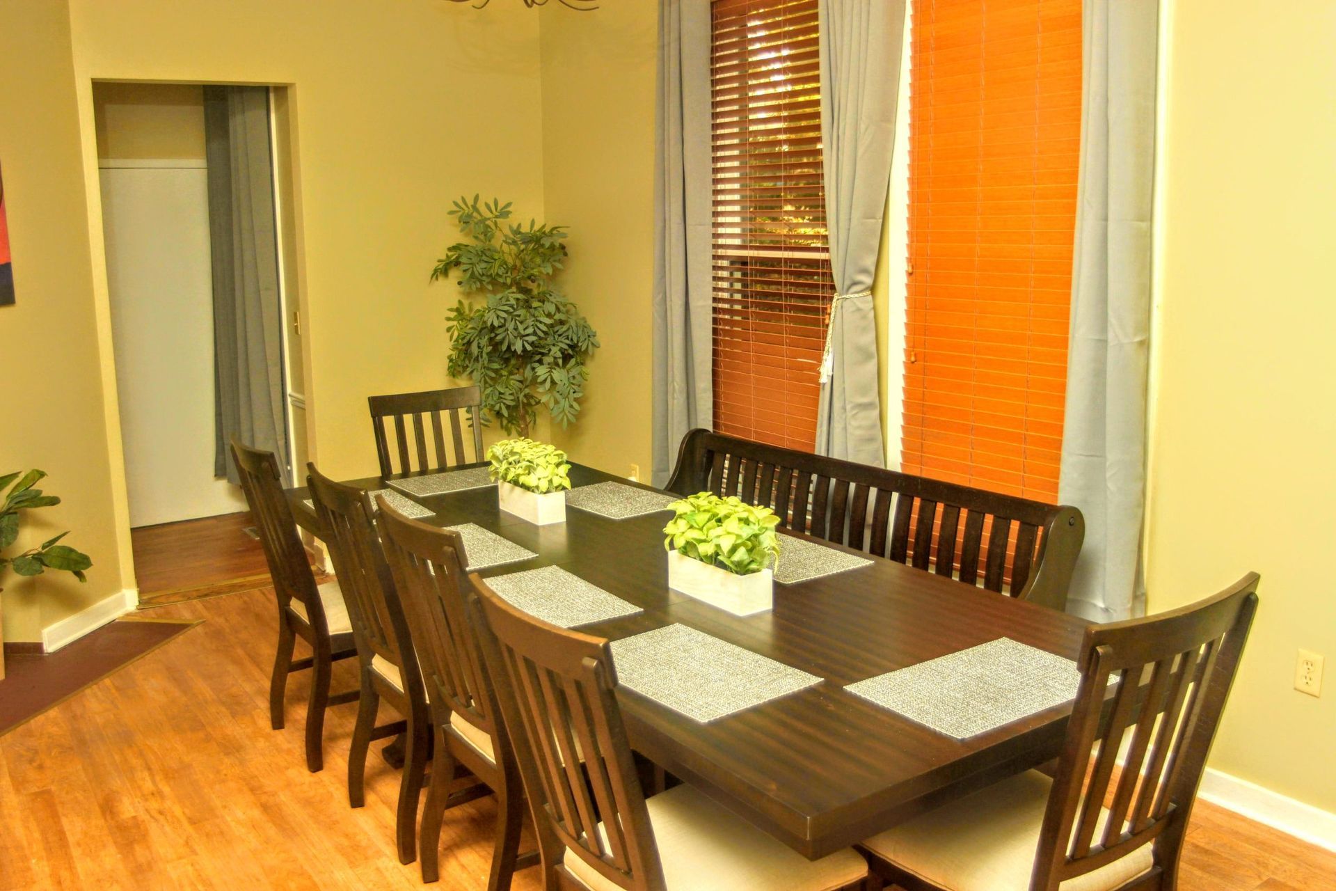 A dining room with a long table and chairs