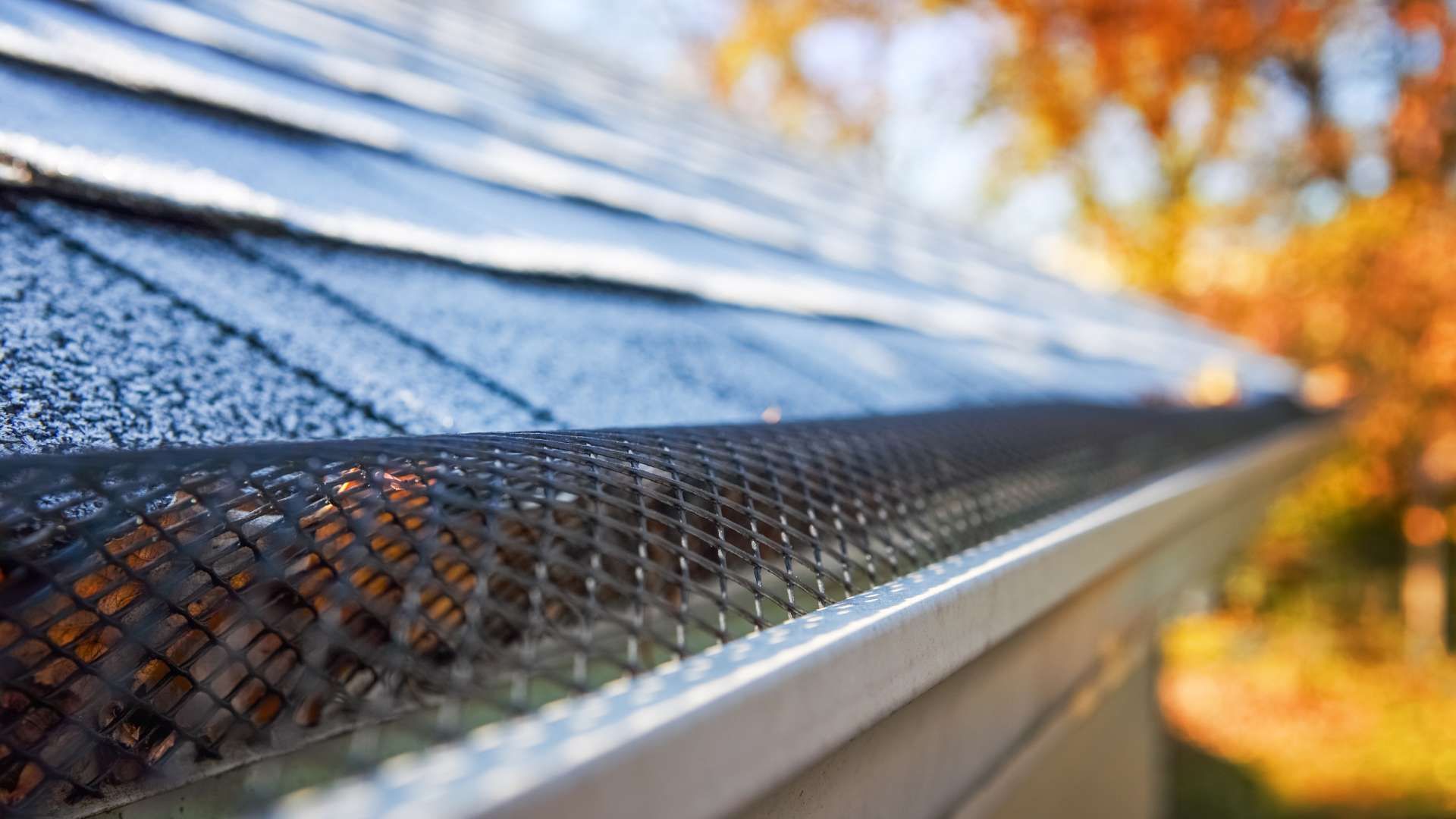 A close up of a gutter on the roof of a house.