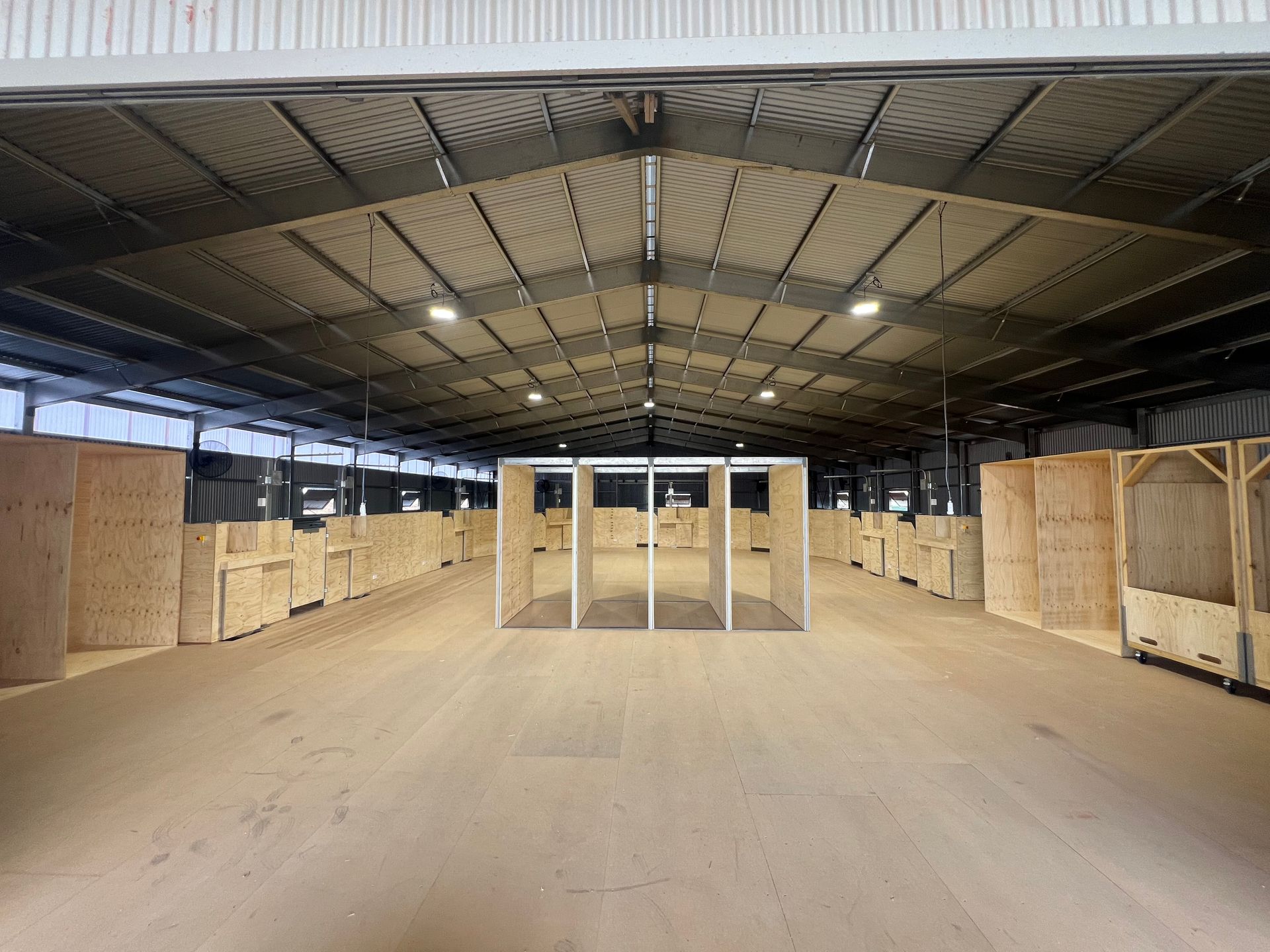 a shearing shed with curved wooden board
