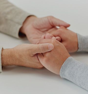 A little girl in a purple dress is being examined by a doctor.