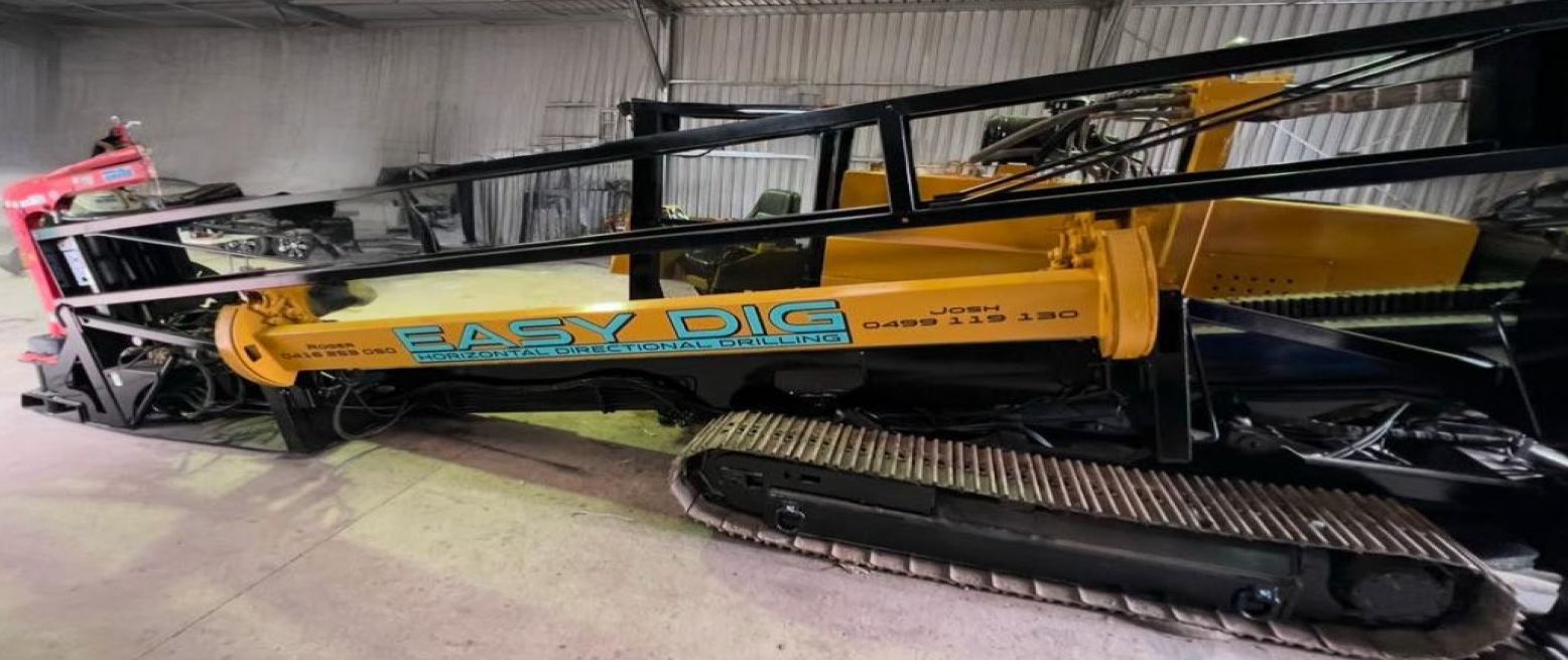 A yellow and black machine is sitting in a warehouse.