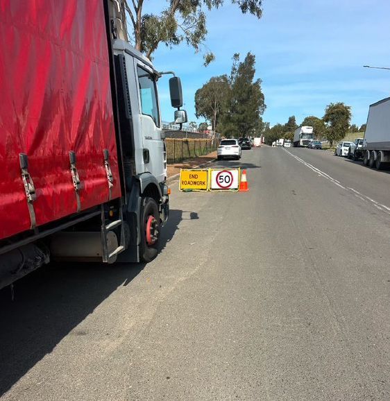 A red truck is parked on the side of the road