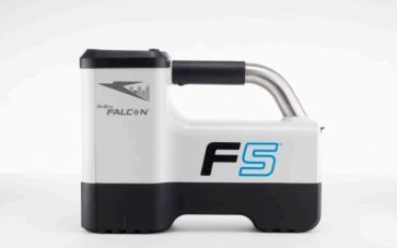 A falcon f5 device is sitting on a white surface.