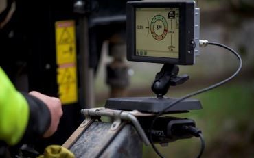 A person is working on a machine with a monitor attached to it