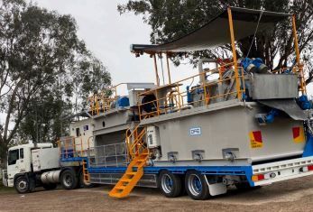 A large truck is parked next to a smaller truck.