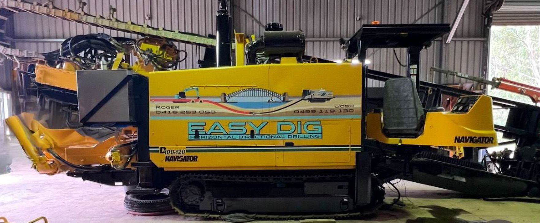 A large yellow machine is sitting in a warehouse.