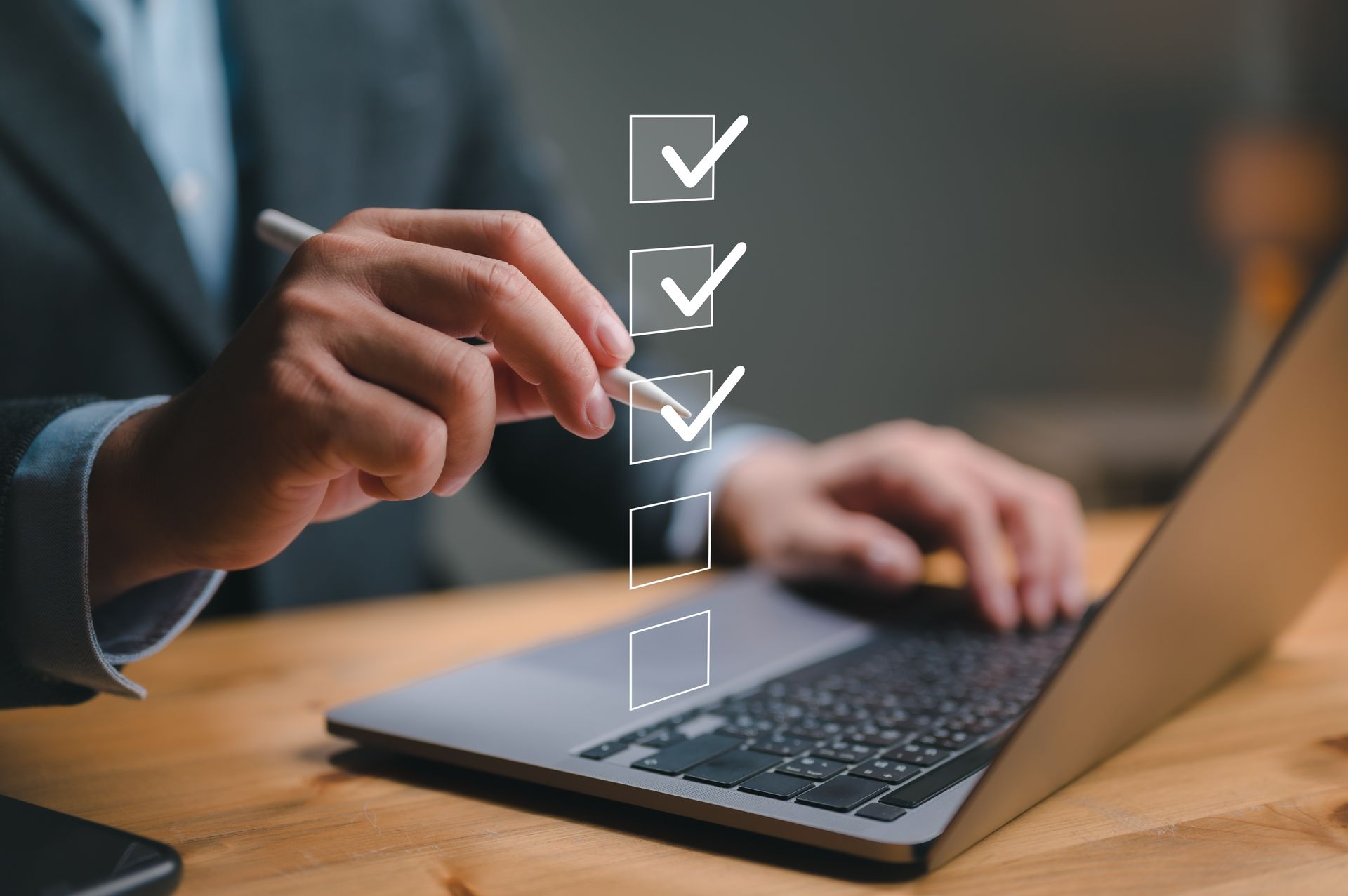 A man is checking off a checklist on a laptop computer.