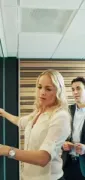 Team reviewing colorful sticky notes on a glass board in a modern office