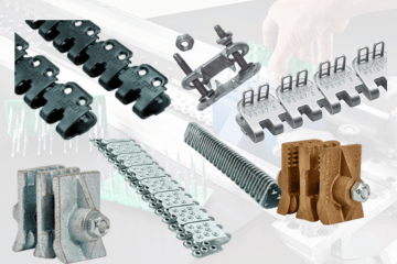 Assorted metal conveyor belt lacing connectors, including clips and clamps, arranged against a white backdrop.