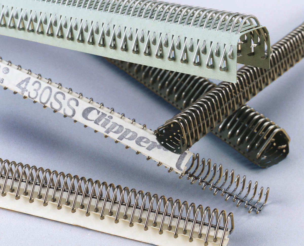 Close-up of several metal clipper staples for industrial use on a white background.