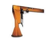 Yellow jib crane, used for lifting, with a wide, tapered base.