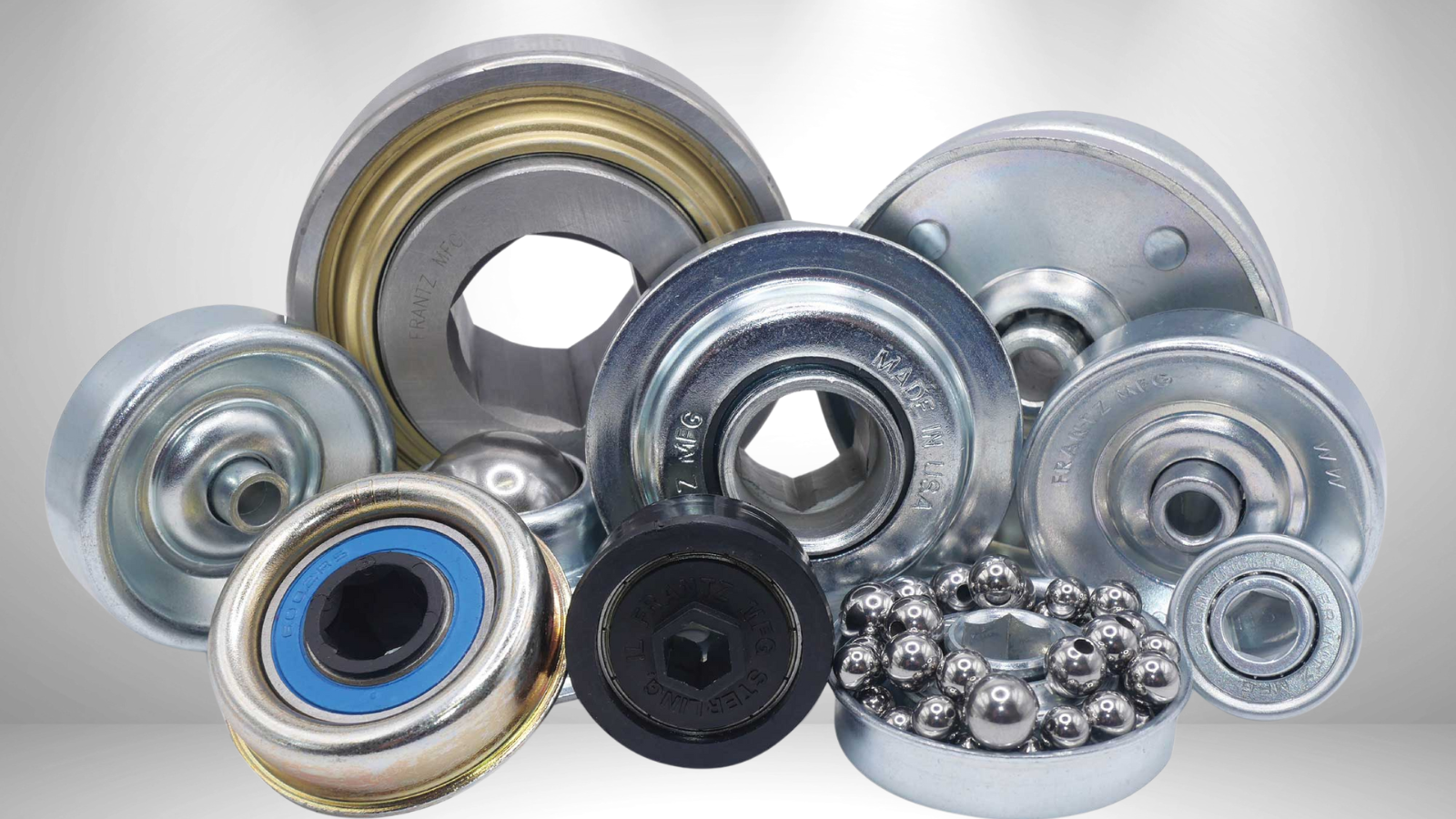 Collection of various industrial bearings, mostly metallic, some with visible ball bearings.