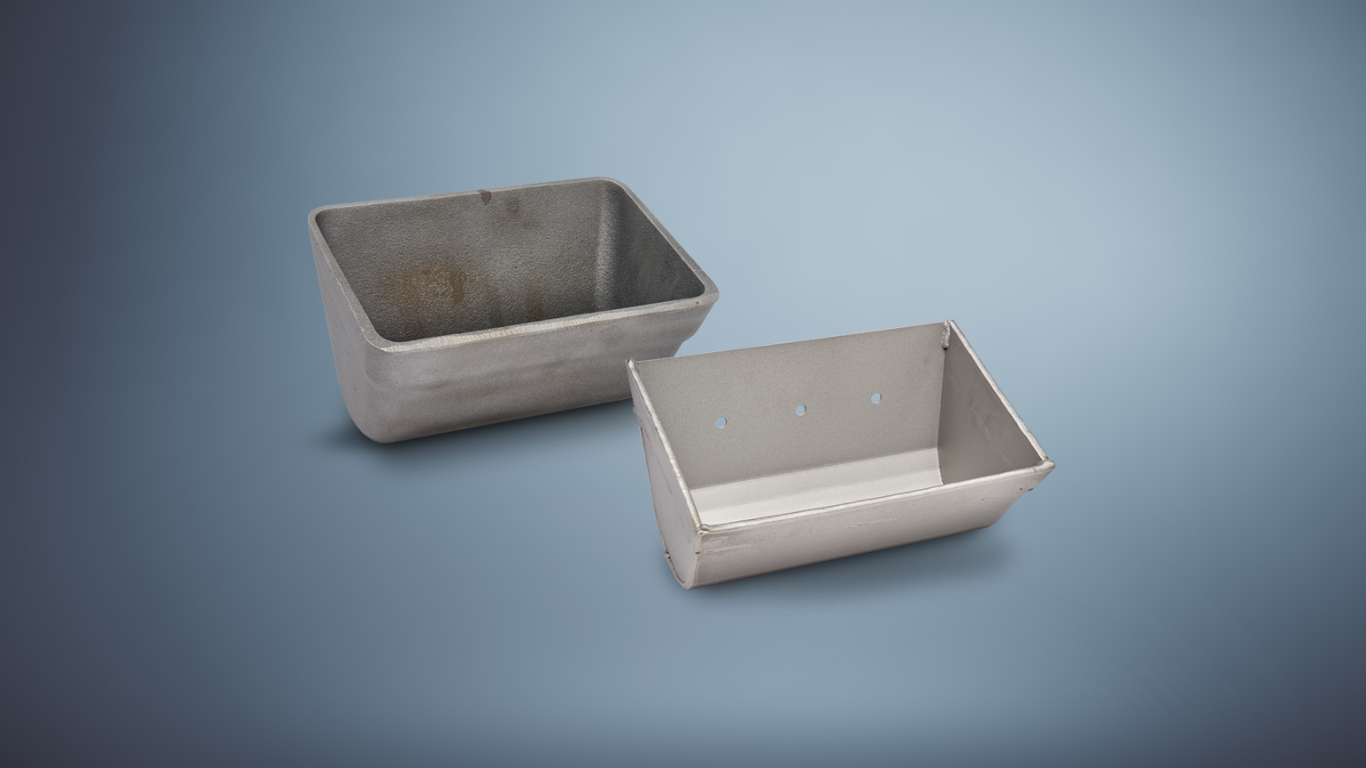 One iron elevator bucket and one steel fabricated elevator bucket on a gray background.