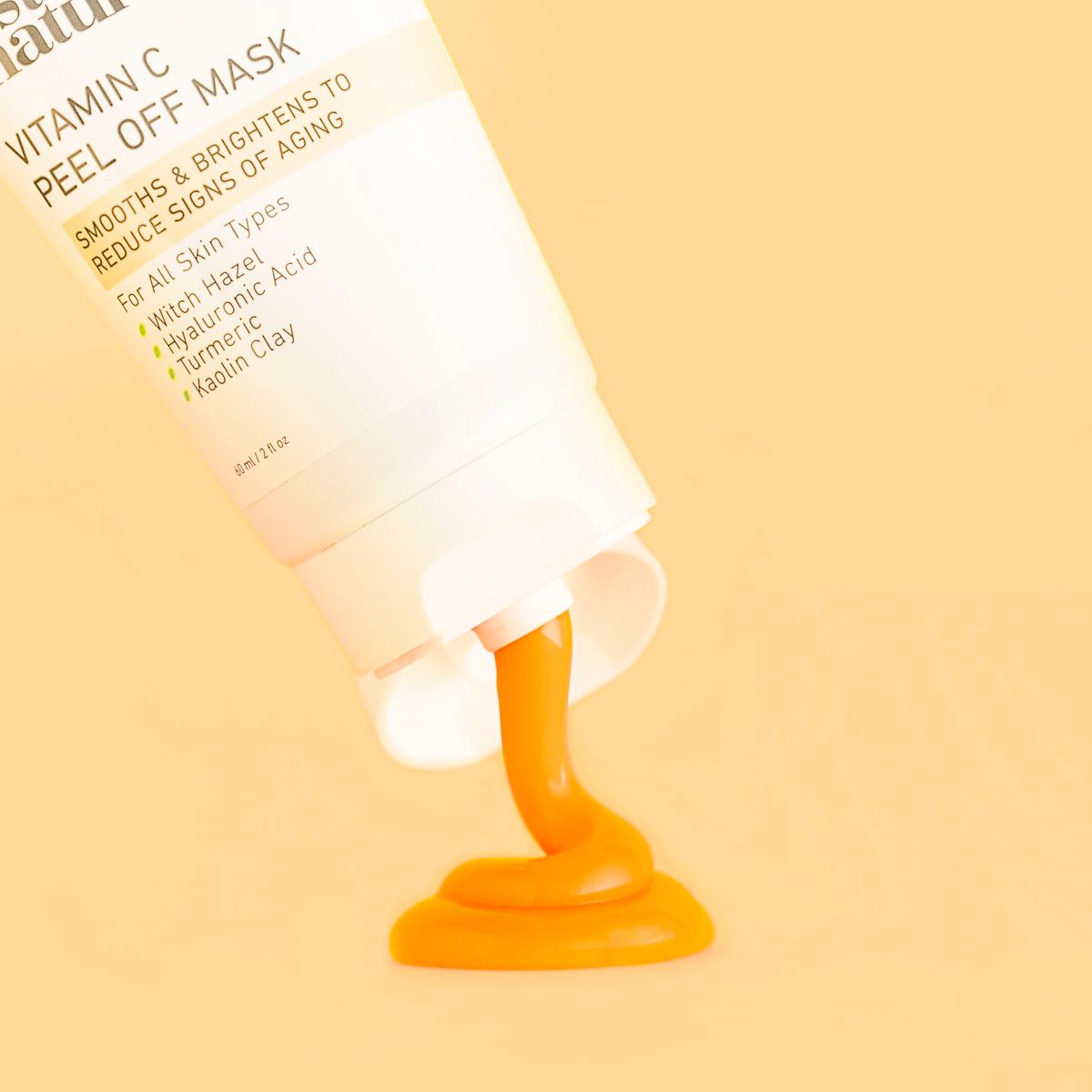 Instanatural skincare beauty product on orange paper, upside down dispensing product. By JAM Creative, product photographers.
