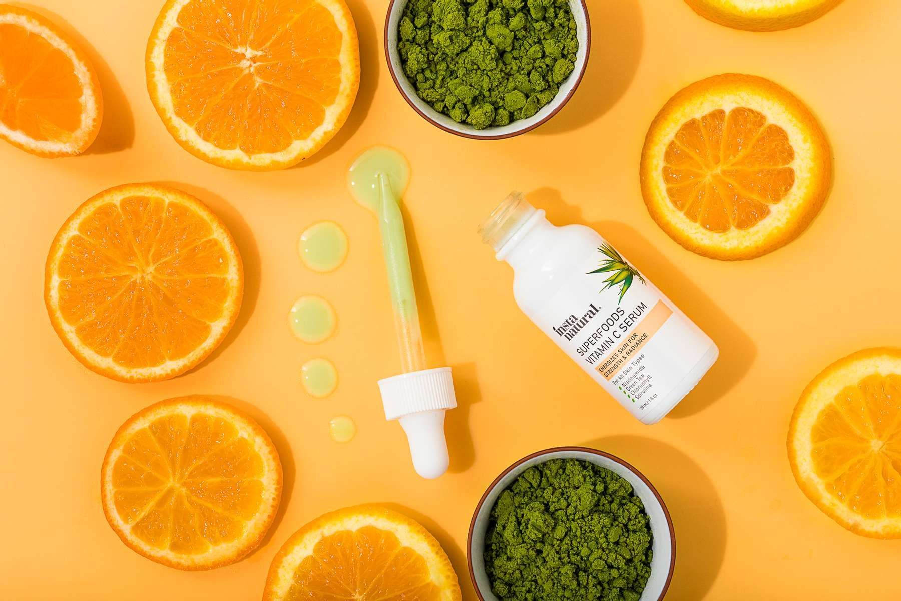 Instanatural skincare beauty product on orange paper with fresh oranges + matcha. By JAM Creative, product photographers.
