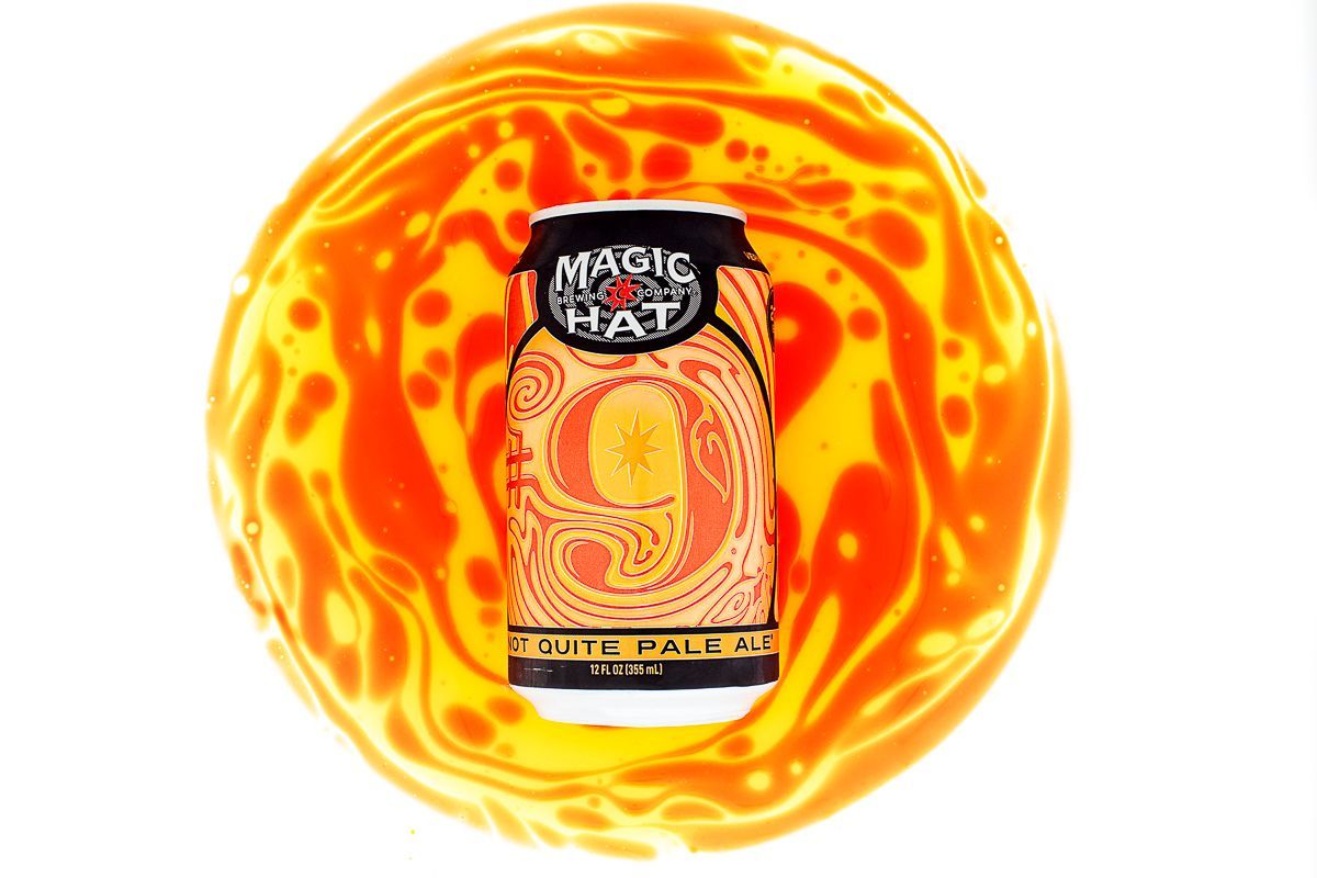 Beverage product photography of Magic Hat Number 9 beer on circle of orange and yellow. Product photographer: JAM Creative.