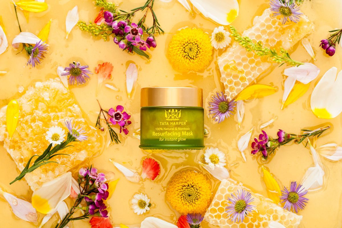 Tata Harper skincare beauty product surrounded by honey, honeycomb + fresh flowers. By JAM Creative, product photographers.