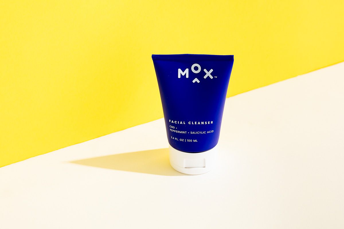 Mox skincare beauty product on yellow and white paper. By commercial product photographers at JAM Creative in Burlington VT.