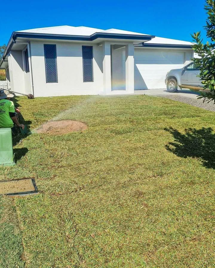 A House with A Freshly Laid Lawn Being Watered Under a Blue Sky — Top Notch Turf in Cloncurry, QLD