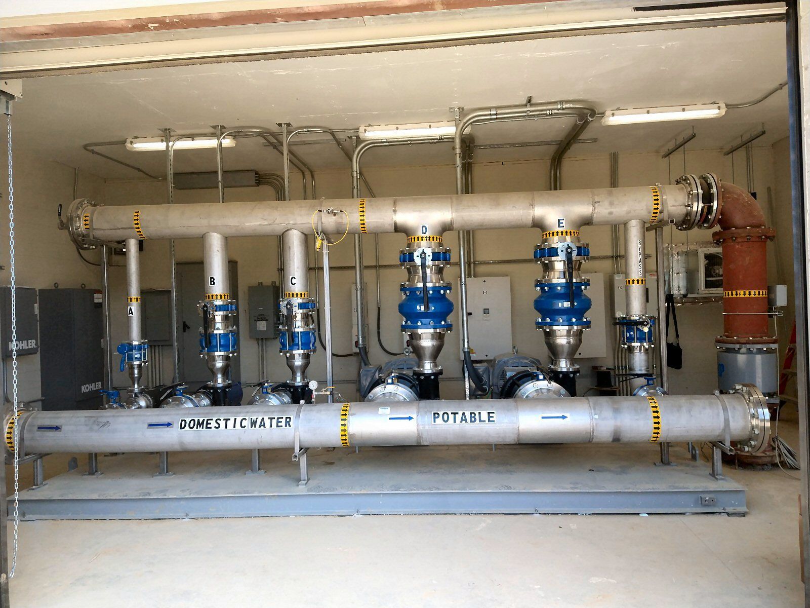 A room with a lot of pipes and a sign that says potassium