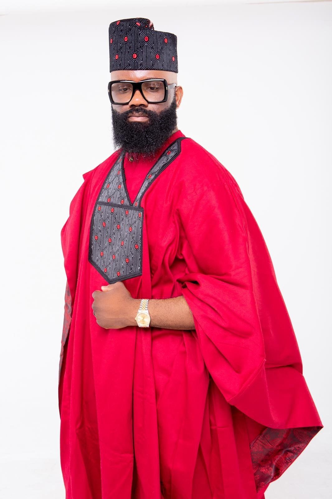 Red agbada with black and red detailed embroided megida cap