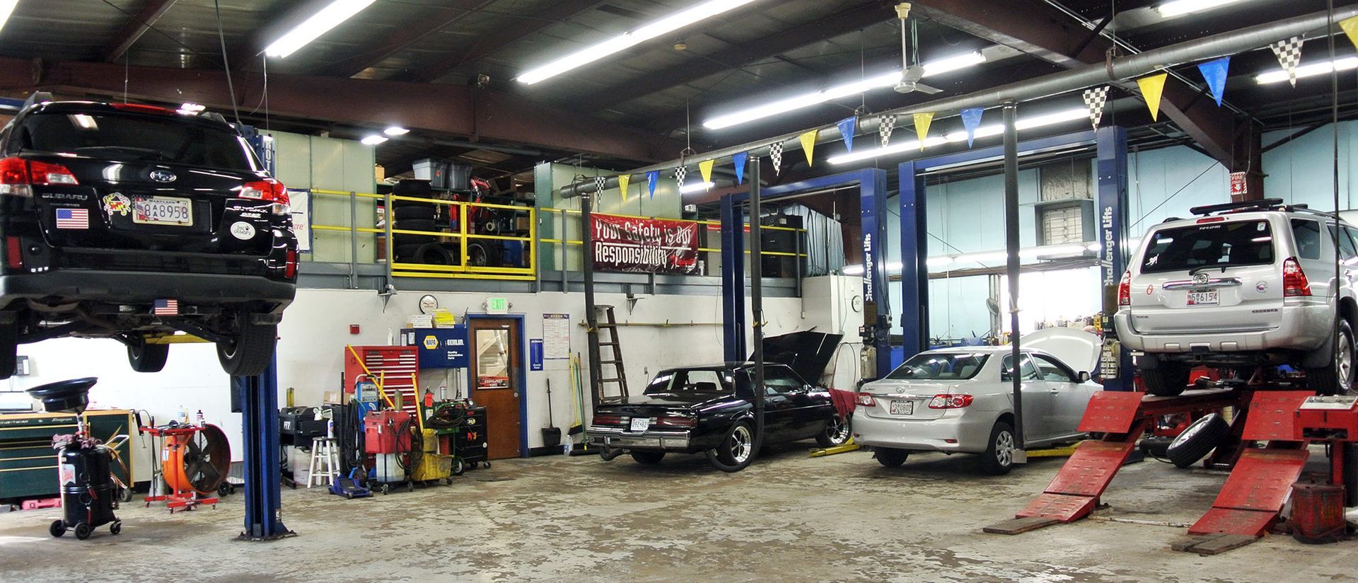 Full Service Auto Repair Facility With Multiple Vehicles Inside Shop | Neubauer's Auto Repair