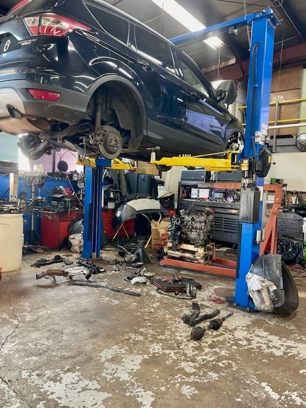 SUV Undergoing Suspension And Brake Inspection On Vehicle Lift | Neubauer's Auto Repair