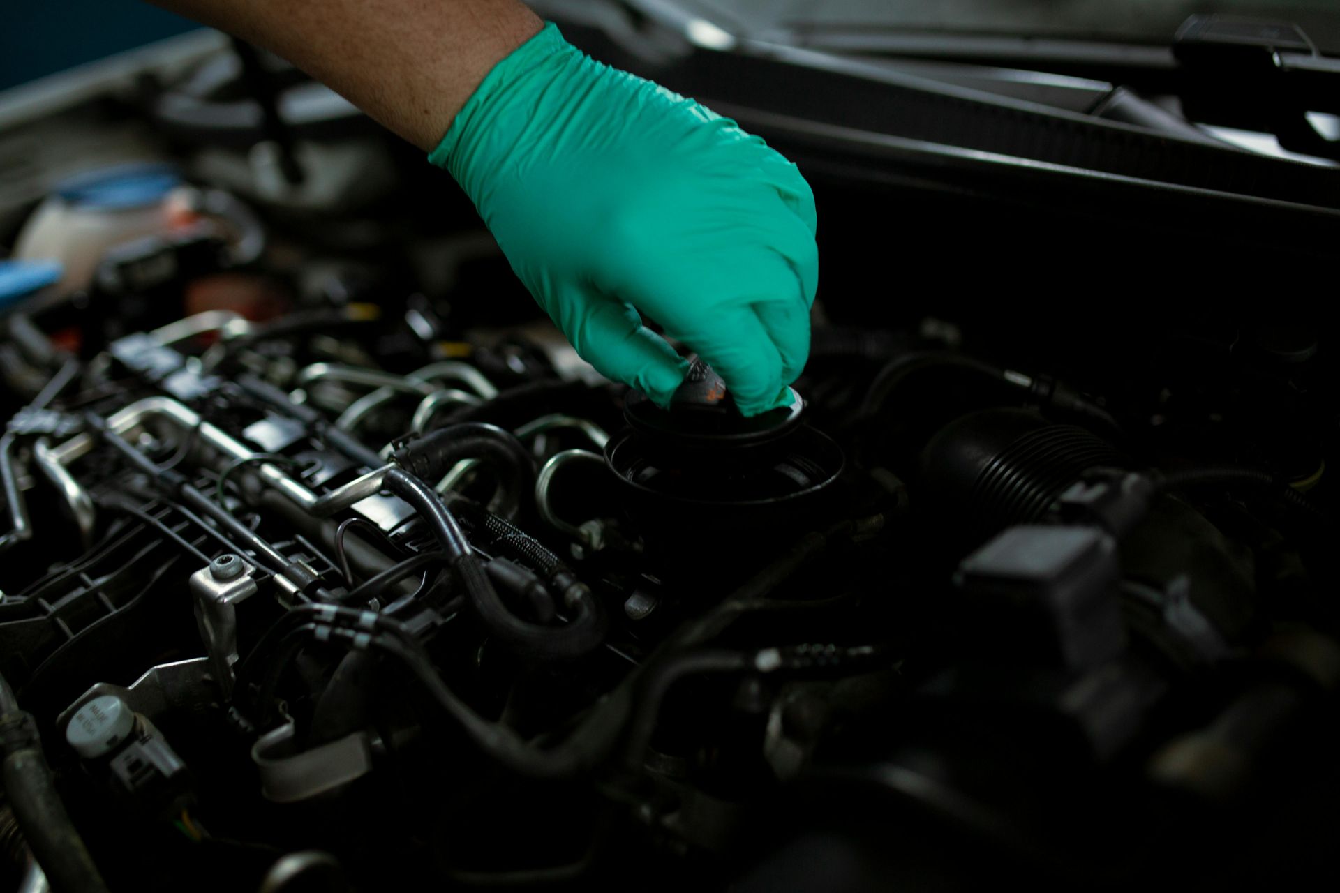 Mechanic Performing Professional Engine Oil Change Service | Neubauer's Auto Repair