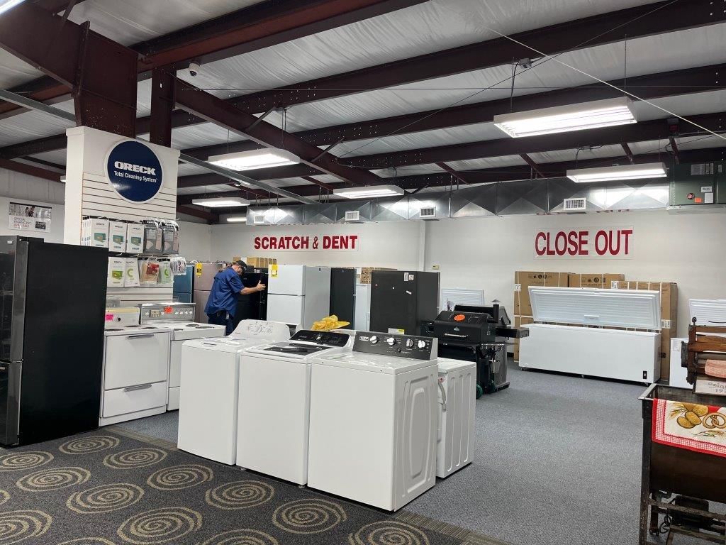 A store filled with lots of appliances and a sign that says `` close out ''.