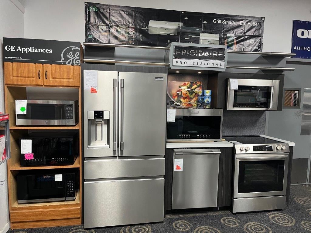 A display of stainless steel appliances in a store