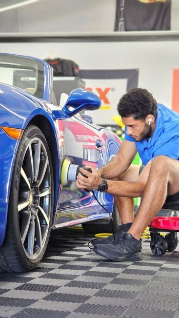 A CarZmedics paint protection specialist paint correcting a Porsche