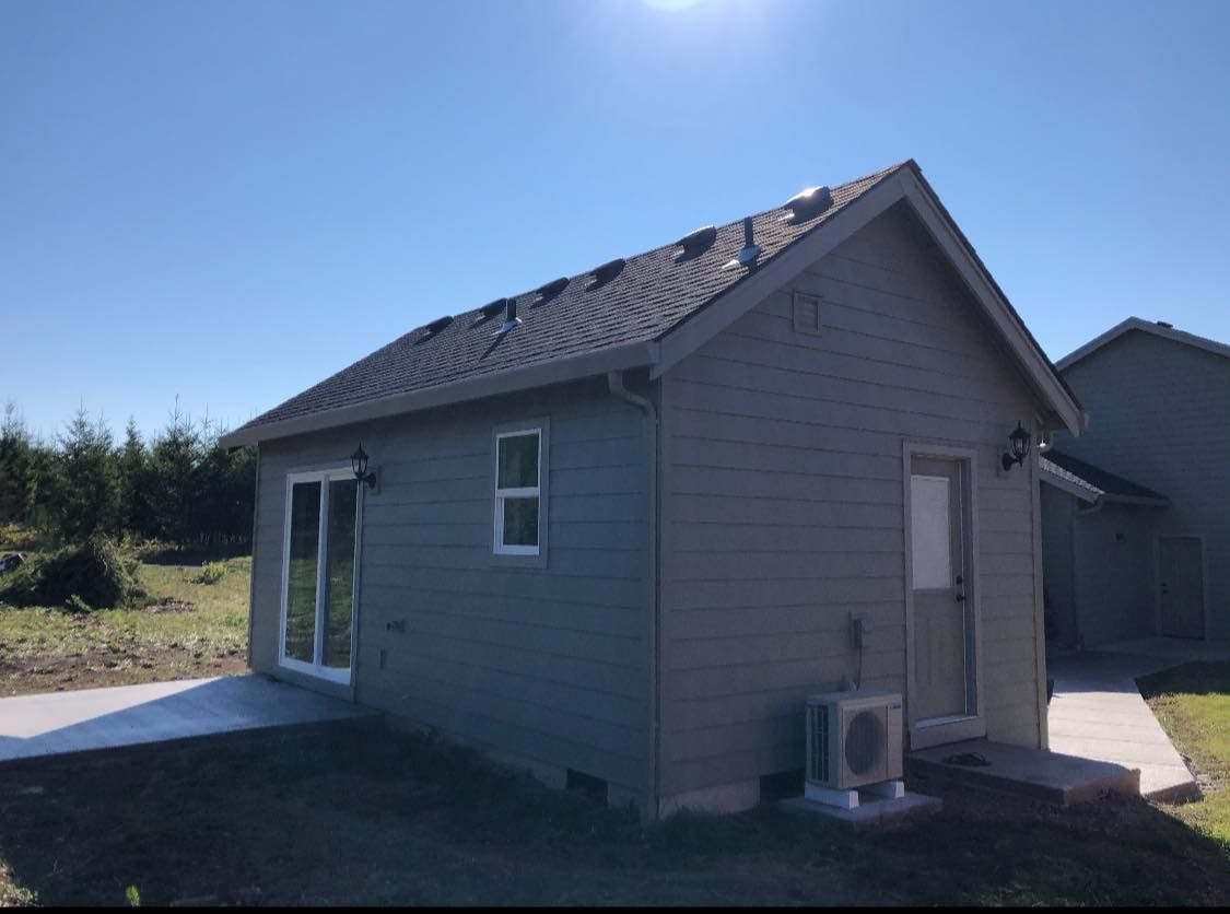 A small house with a sliding glass door and a window