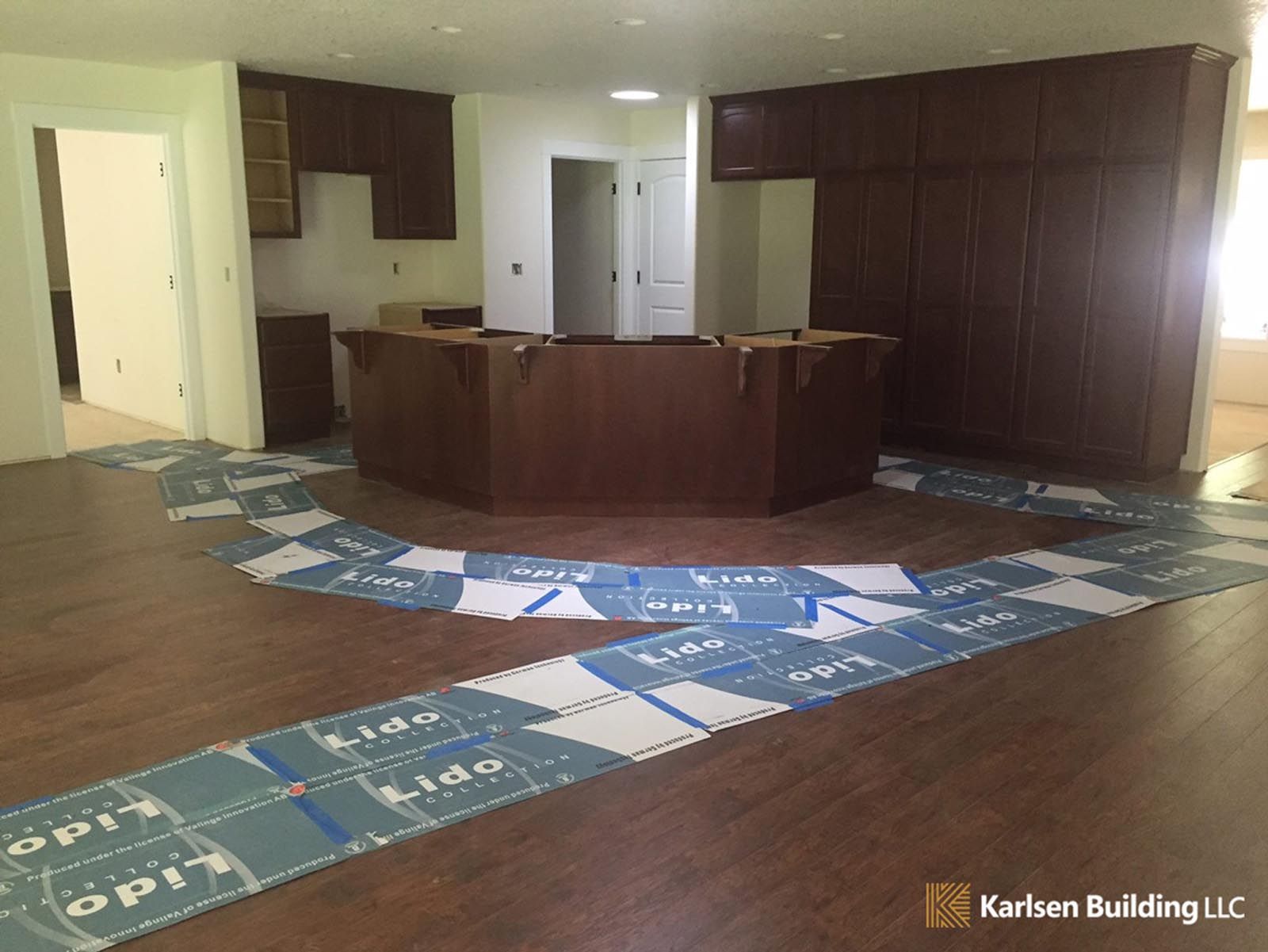 A large room with hardwood floors and a counter in the middle.