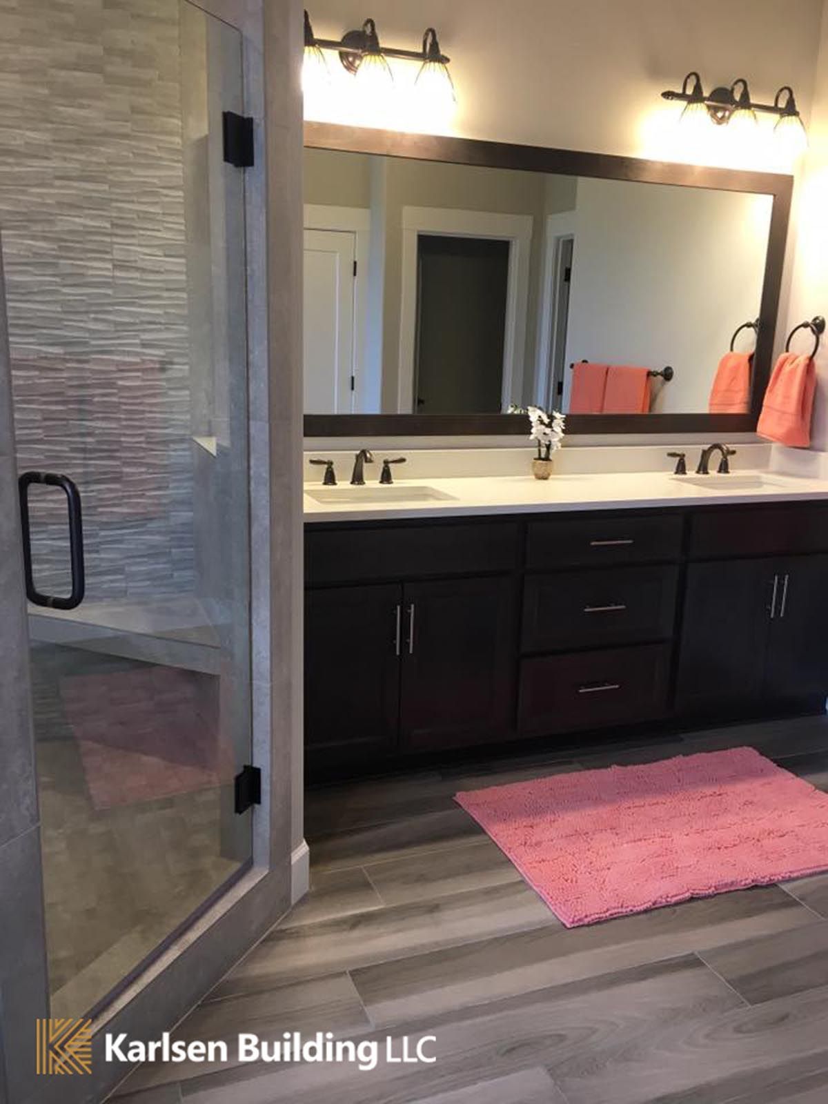 A bathroom with two sinks and a large mirror