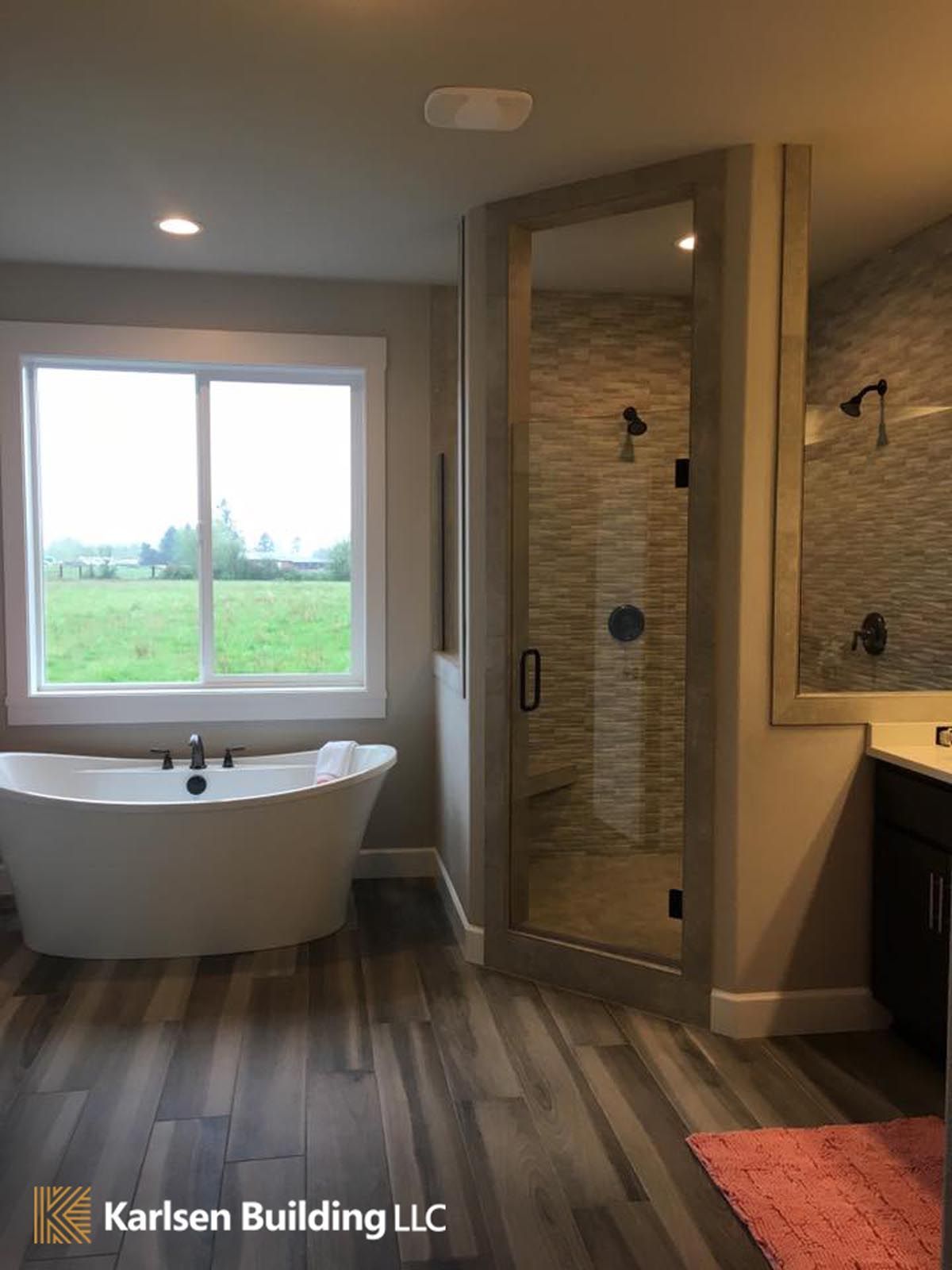 A bathroom with a bathtub and a shower.