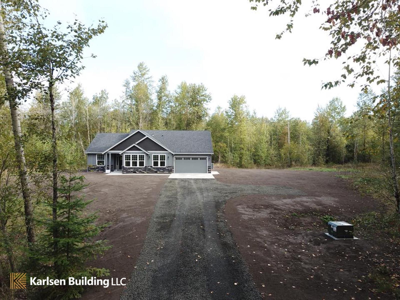 An aerial view of a house in the middle of a forest