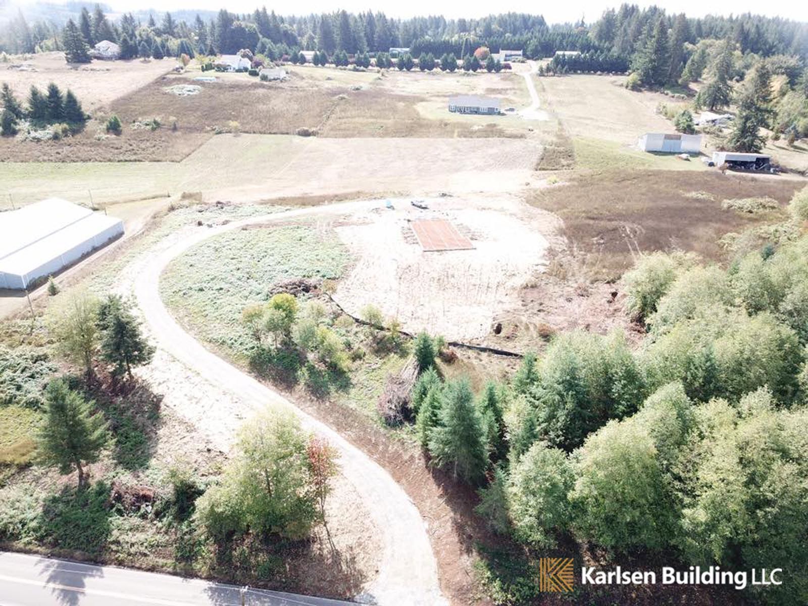 An aerial view of a road going through a field