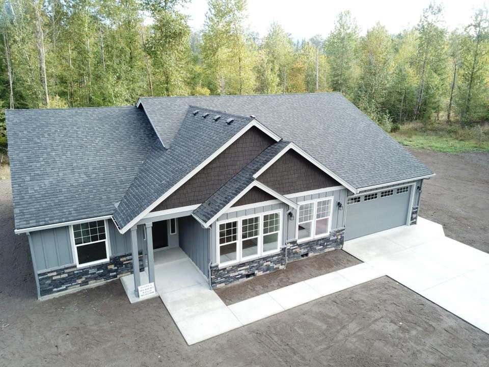 An aerial view of a house with a black roof