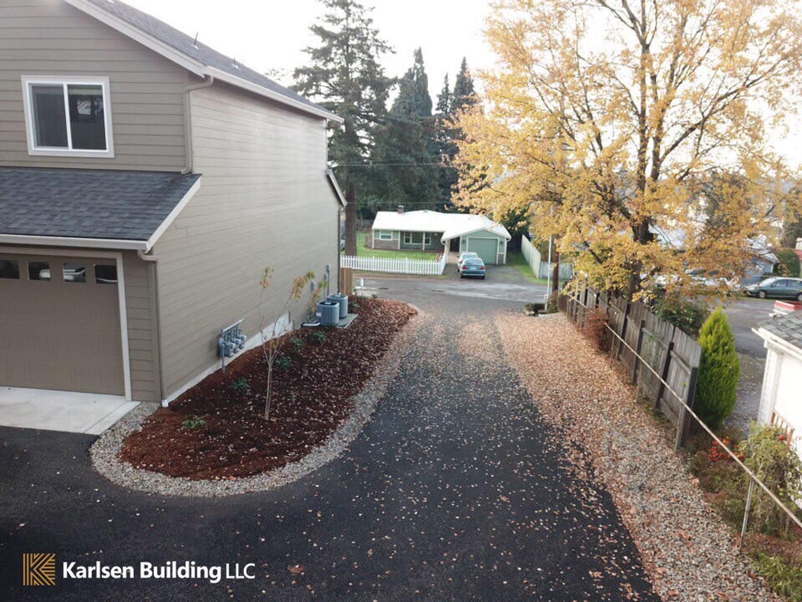 An aerial view of a house and driveway taken by karlsen building llc