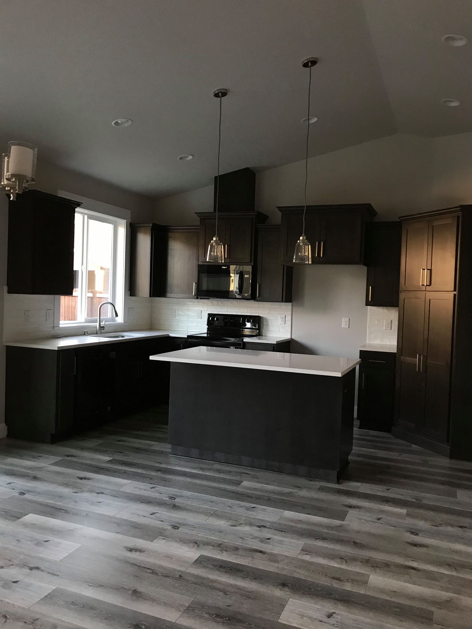A kitchen with a large island in the middle of the room.