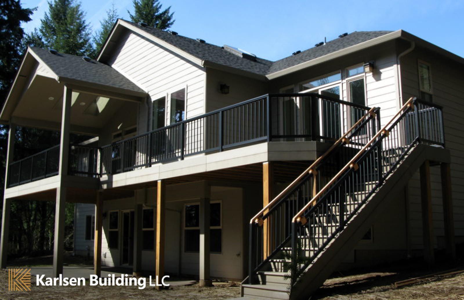 A large house with a large deck and stairs built by karlsen building llc