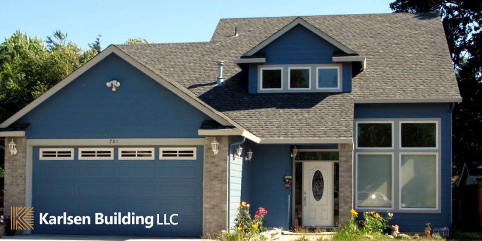 A blue house with the words karlsen building llc on it