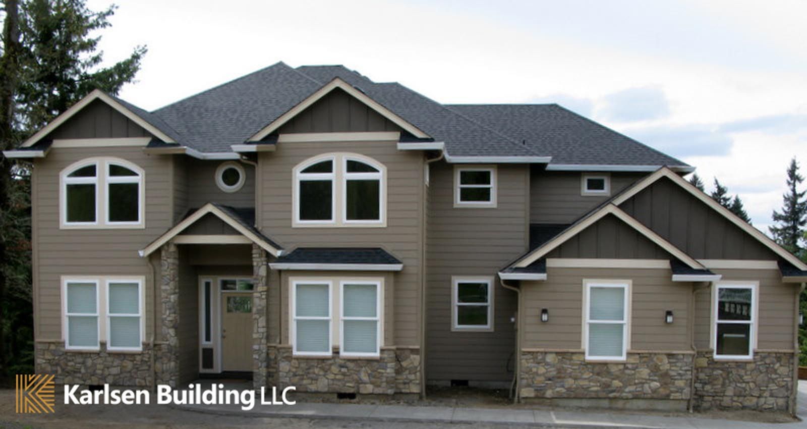 A large house with the words karlsen building llc on the bottom