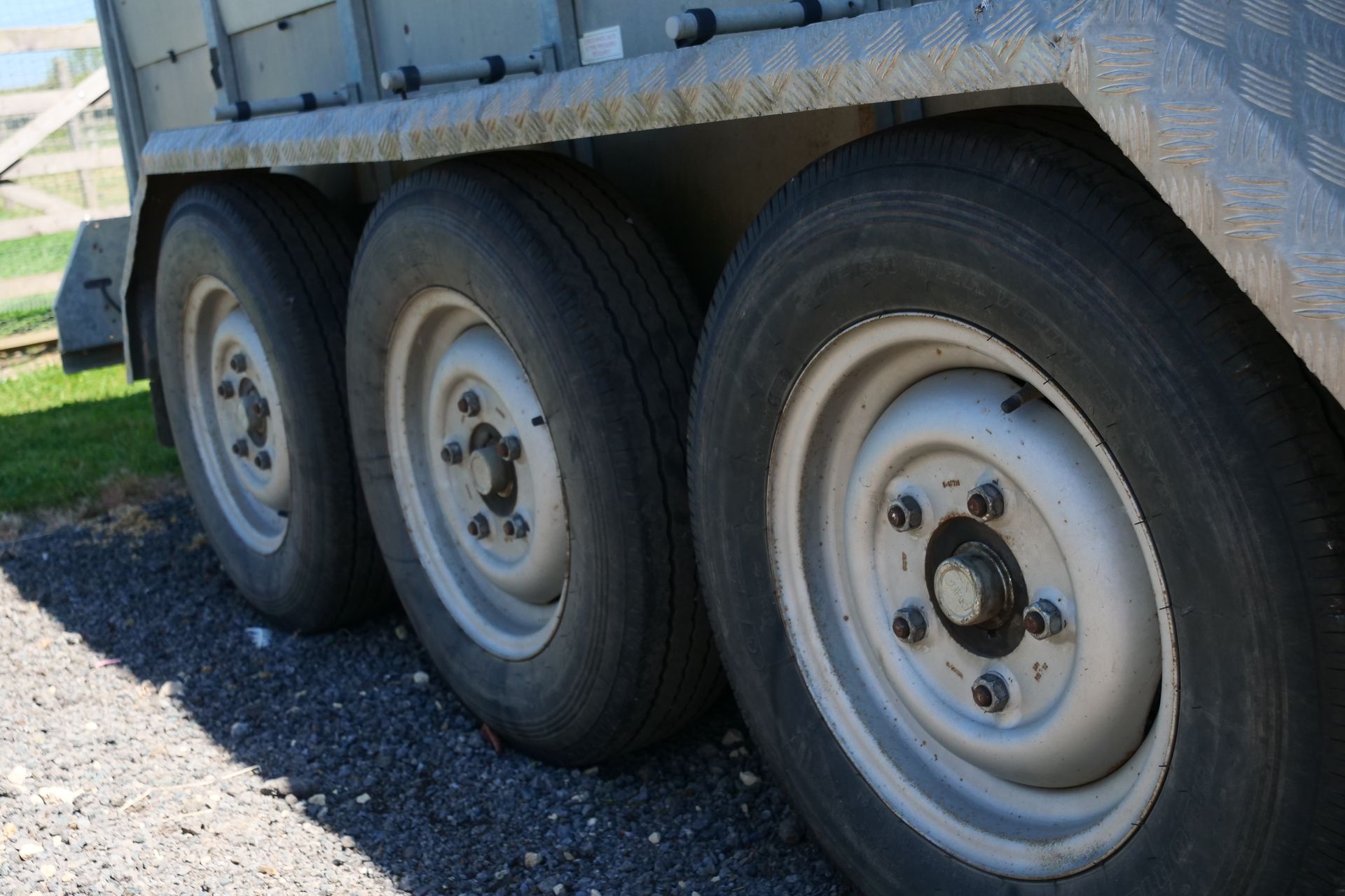 A close up of three tires on a trailer