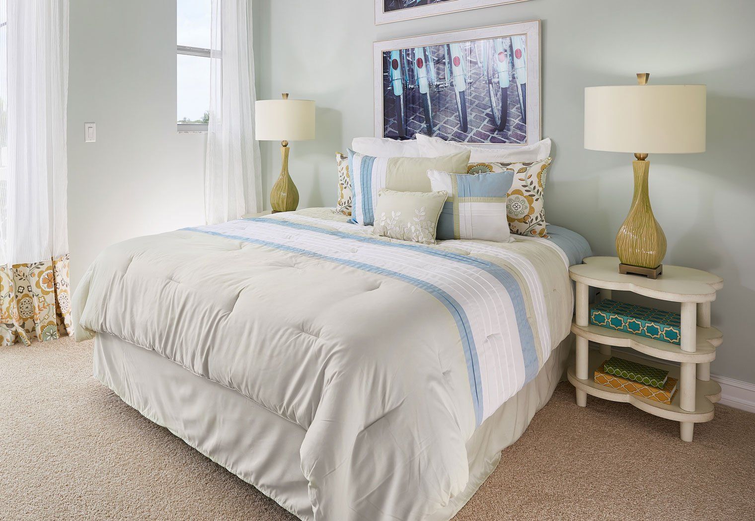 A Blue, White, and Off-White, Bedroom with a Bicycle Theme in a Model Home